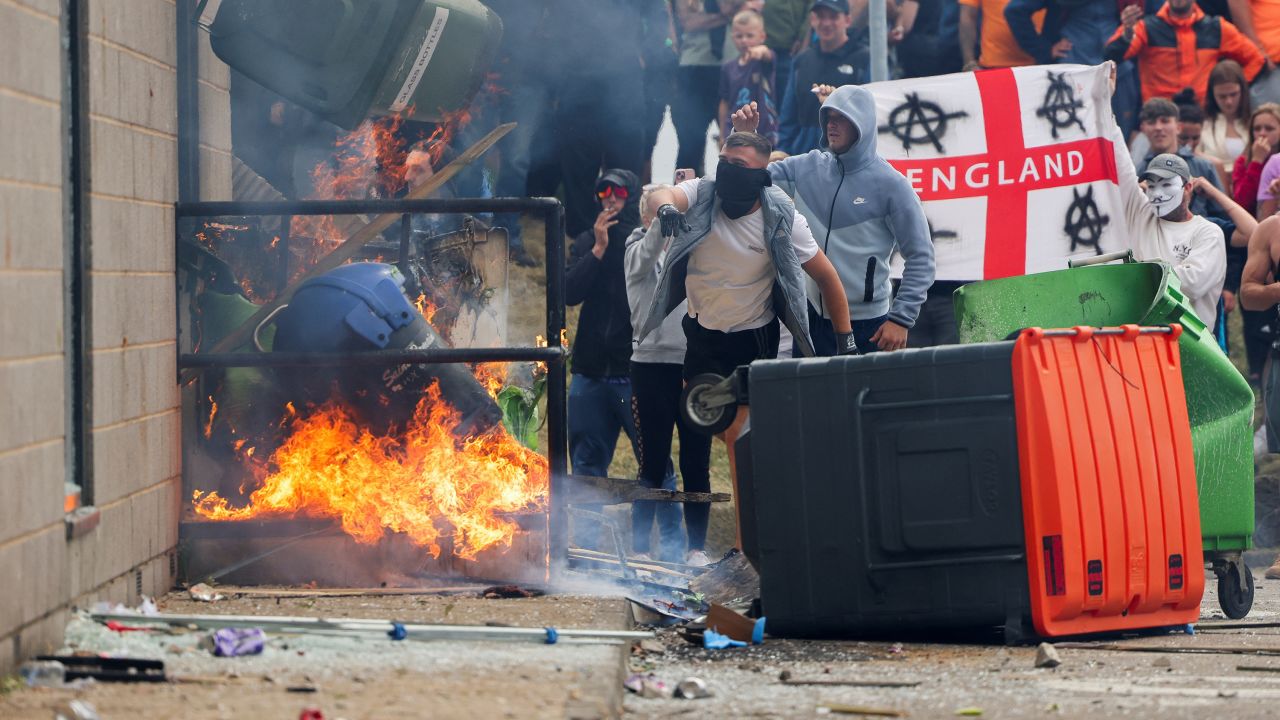 Protestors throw a garbage bin on fire outside a hotel in Rotherham, Britain, August 4, 2024.