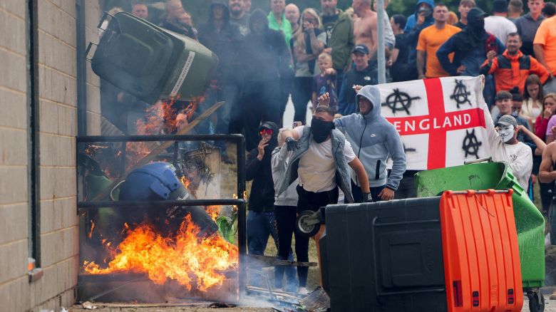 Protestors throw a garbage bin on fire outside a hotel in Rotherham, Britain, August 4, 2024.