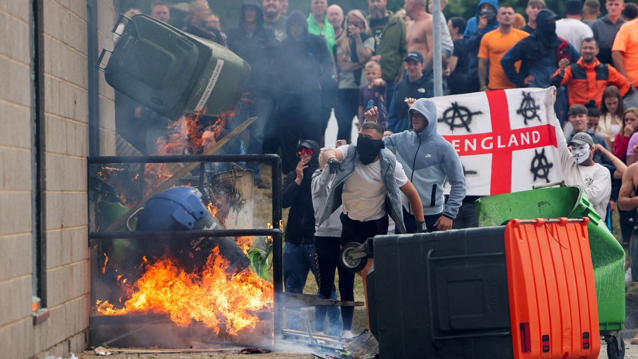 Protestors throw a garbage bin on fire outside a hotel in Rotherham, Britain, August 4, 2024.