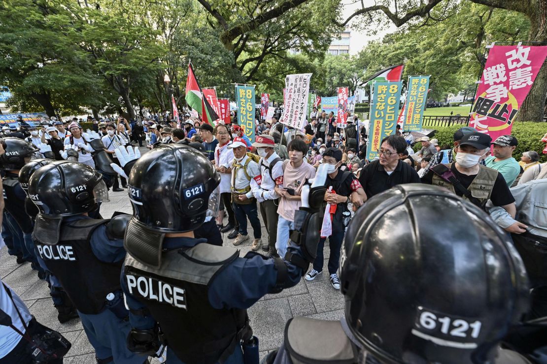 Riot-police guard as anti-war and anti-nuclear protesters gather outside the Atomic Bomb Dome during the 79th Atomic Bombing Day anniversary in Hiroshima, Japan, on August 6, 2024.