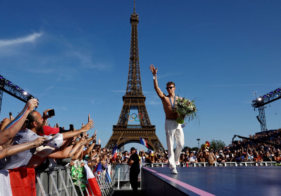 Medallists parade in front of the Eiffel Tower during the Games.