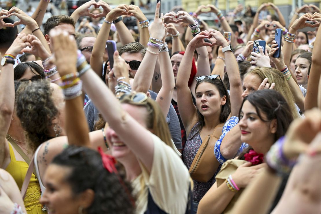 Fans of the singer Taylor Swift make a heart shape with their hands as they gather following the cancellation of three Taylor Swift concerts at Happel stadium after the government confirmed a planned attack at the venue, in Vienna, Austria on Thursday. REUTERS/Elisabeth Mandl