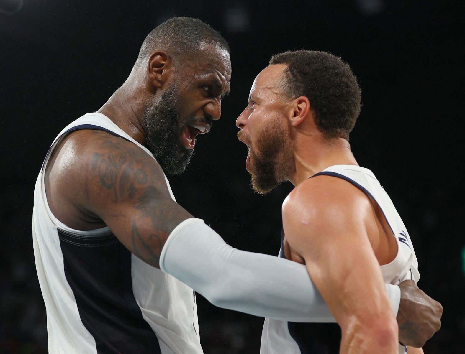 James and Stephen Curry celebrate after the comeback win against Serbia on August 8. Curry scored a game-high 36 points and made nine 3-pointers.