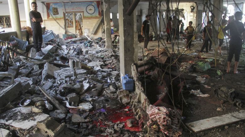 Palestinians inspect the damage after an Israeli strike on a school in Gaza City, August 10, 2024.