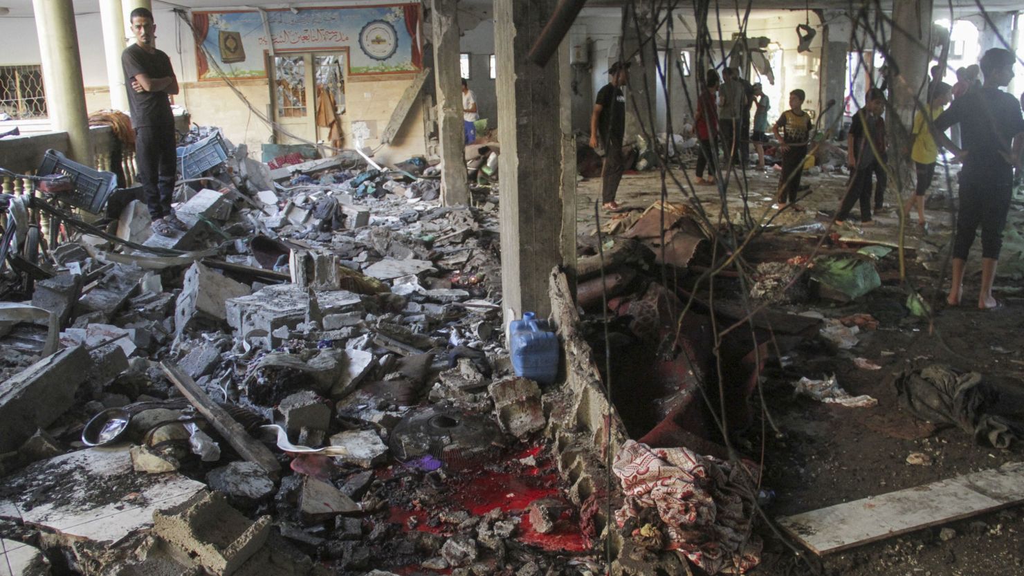 Palestinians inspect the damage after an Israeli strike on a school in Gaza City on Saturday.