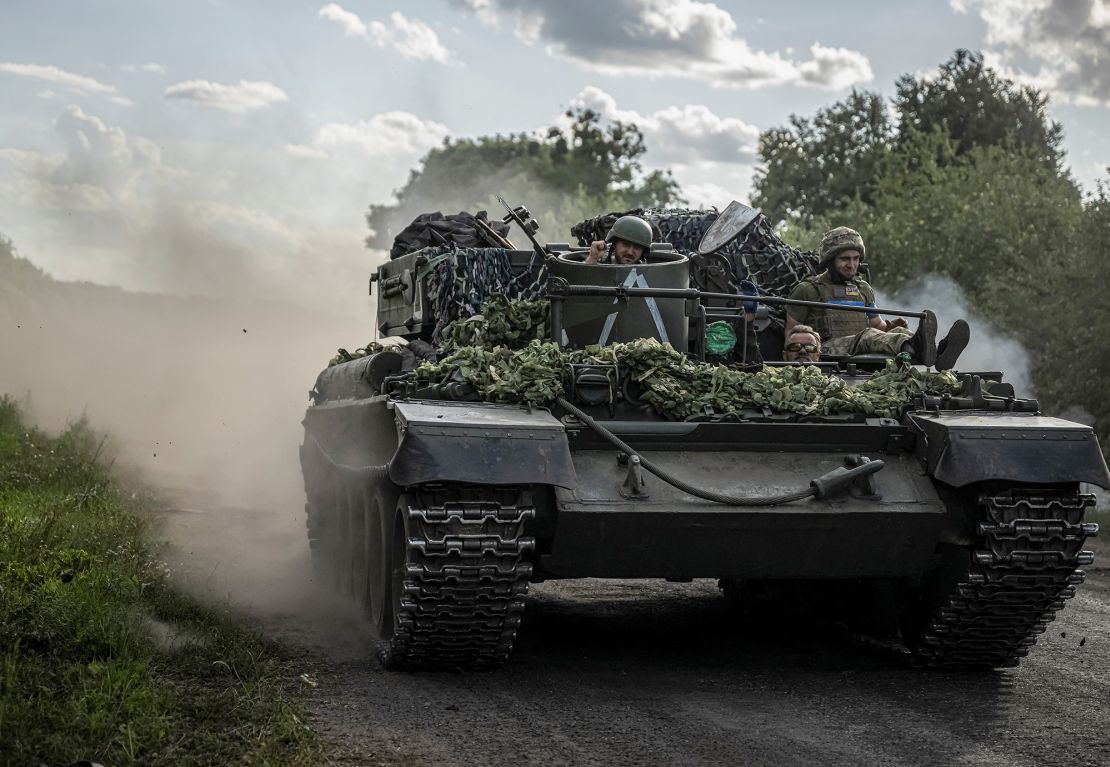 Ukrainian servicemen ride a military vehicle near the Russian border in Sumy region, Ukraine, on August 11, 2024.