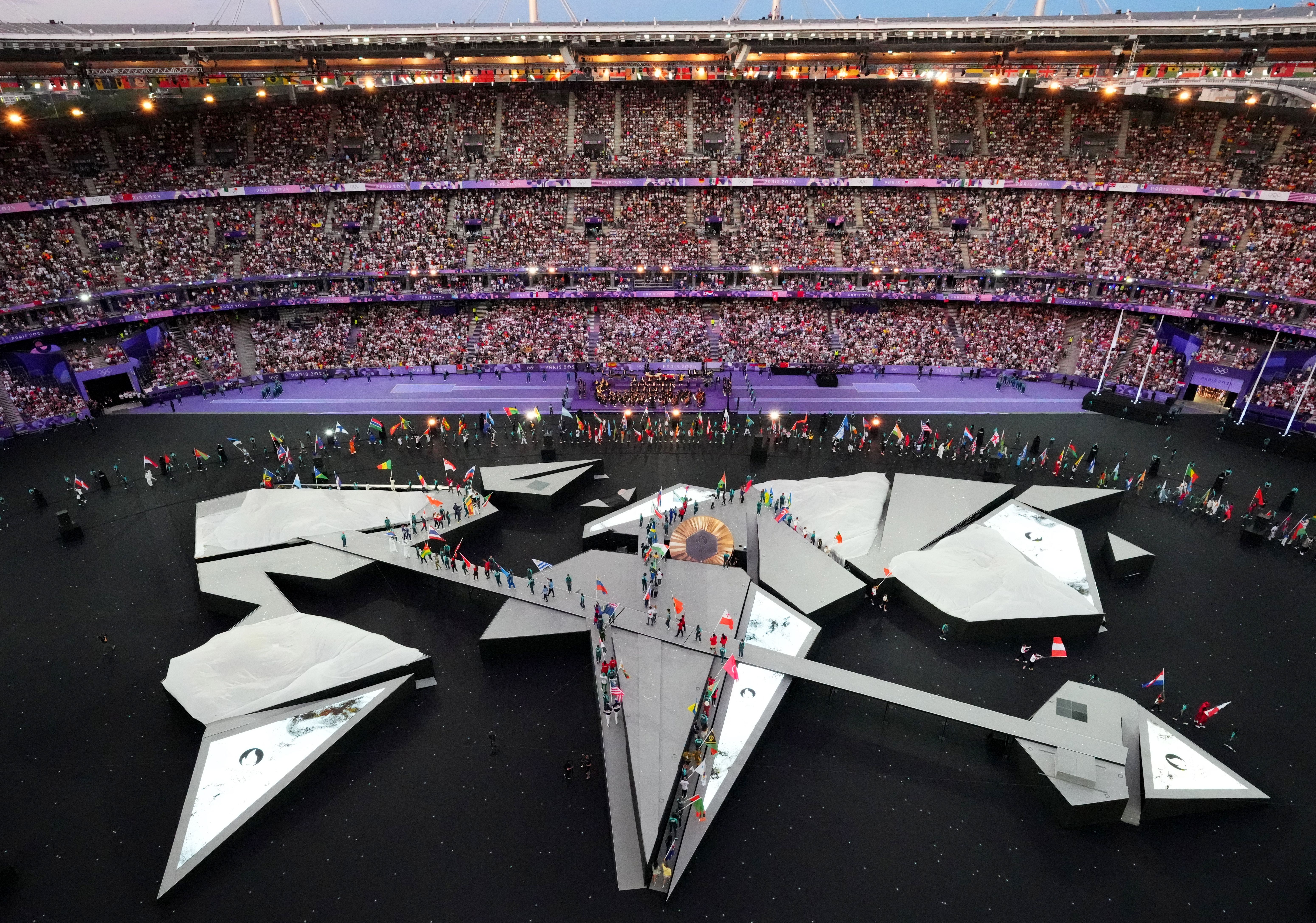 Flagbearers from every country enter the Stade de France during the closing ceremony.