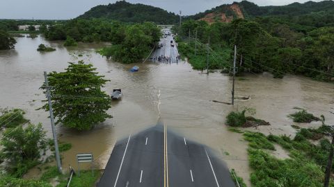 A drone view shows a bridge submerged by the flooded La Plata River in the aftermath of Tropical Storm Ernesto in Toa Baja, Puerto Rico August 14, 2024.  REUTERS/Ricardo Arduengo