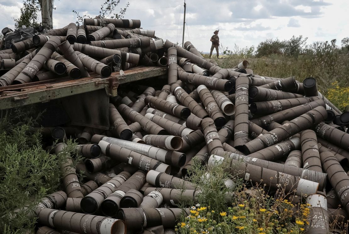 A Ukrainian soldier stands near used shell cartridges as he patrols an area in Ukraine's  Donetsk region.