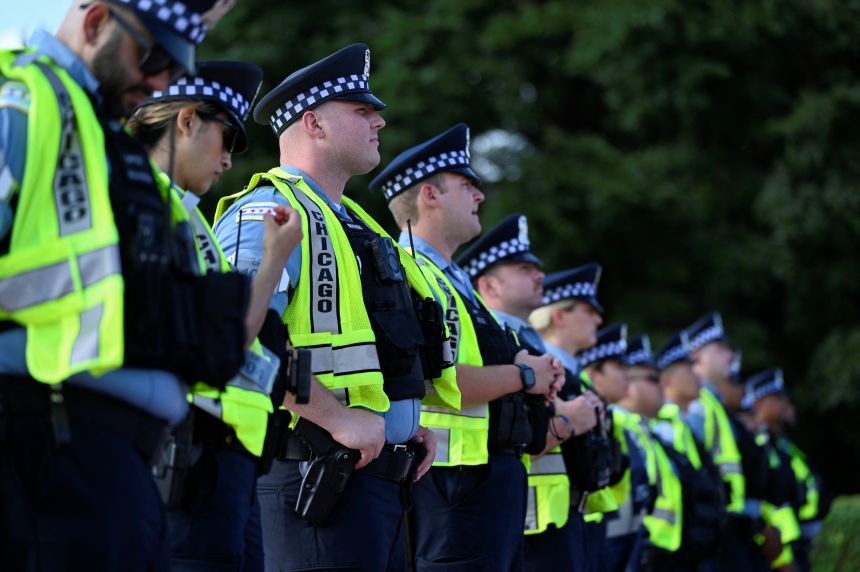 Policemen stand guard during a demonstration calling for justice for Sonya Massey in Chicago on August 17, 2024.