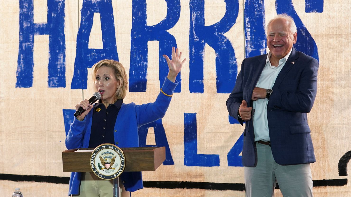 Gwen Walz, wife of U.S. Democratic vice presidential candidate Minnesota Governor Tim Walz speaks next to her husband, as Democratic presidential candidate and U.S. Vice President Kamala Harris and second gentleman Doug Emhoff look on, at a campaign field office, as Harris and Walz make a four-stop bus tour of western Pennsylvania before heading to Chicago for the Democratic National Convention, in Rochester, Pennsylvania, U.S., August 18, 2024. REUTERS/Kevin Lamarque