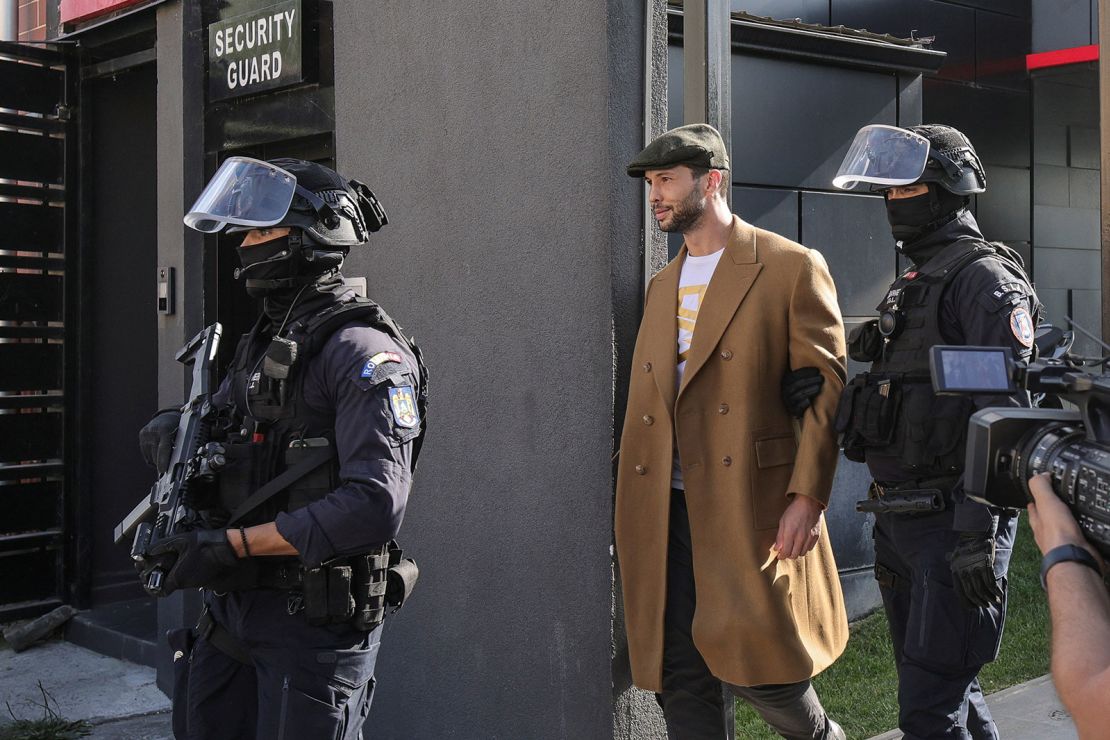 Romanian gendarmes from the Special Intervention Brigade escort Tristan Tate outside the Tate brothers' residence in Pipera, Ilfov, near Bucharest on August 21, 2024.