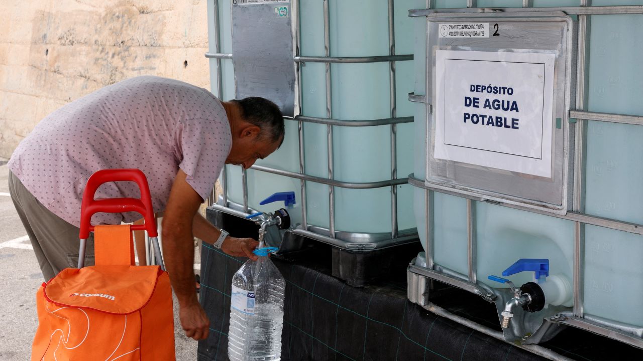 A resident collects water from a tank as tap water has been declared undrinkable as a result of the drought in Teulada, Alicante, Spain, August 19, 2024.