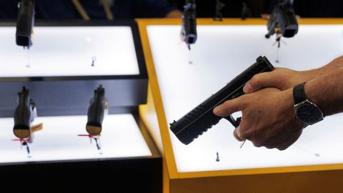 A person tries out a handgun during the annual National Rifle Association (NRA) meeting in Dallas, Texas, U.S., May 17, 2024.