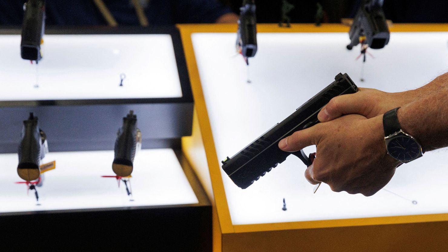 A person tries out a handgun during the annual National Rifle Association meeting in Dallas, Texas, U.S., May 17, 2024.