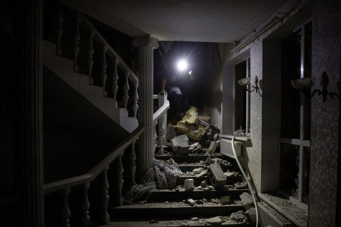 A man walks through the rubble inside a hotel hit by a Russian missile.