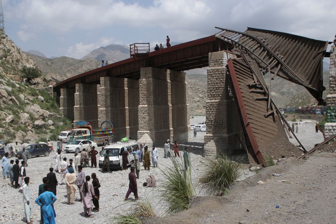 Locals wait as the road is blocked after railway tracks collapsed, a day after separatist militants conducted deadly attacks, in Bolan district of Pakistan's restive province of Balochistan, Pakistan August 27, 2024. REUTERS/Naseer Ahmed