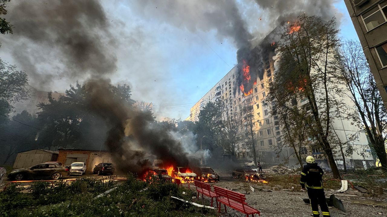 A firefighter looks at an apartment building and cars which burn after a Russian air strike, amid Russia's attack on Ukraine, in Kharkiv, Ukraine August 30, 2024.