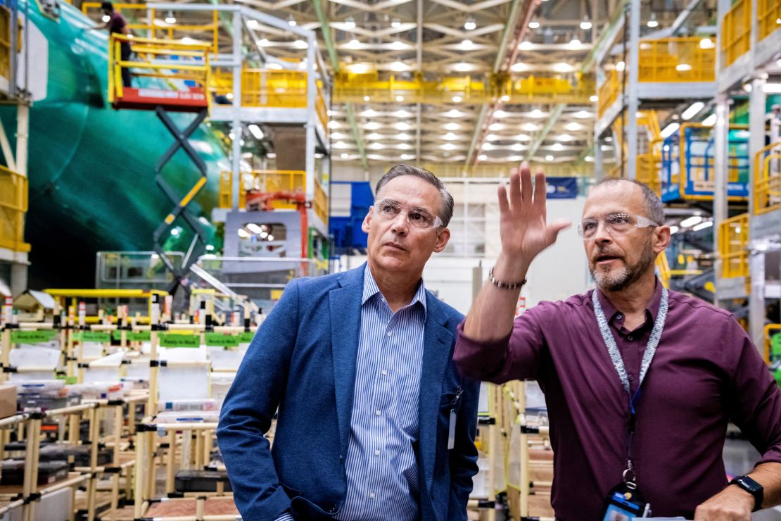 Boeing's new CEO Kelly Ortberg (left) visits the company's Everett, Washington, plant in August, shortly after she took over as CEO and before the union members' strike that began September 13.