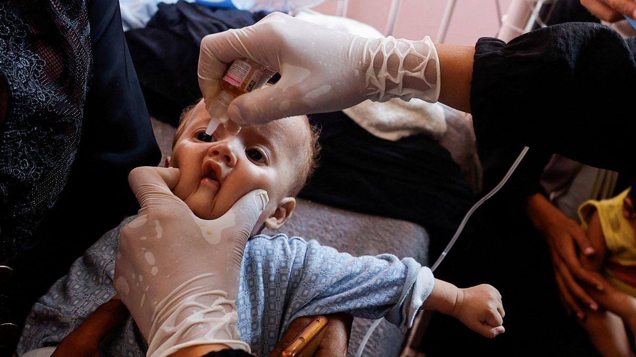 A Palestinian child is vaccinated against polio, amid the Israel-Hamas conflict, at Nasser hospital in Khan Younis in the southern Gaza Strip, August 31, 2024.