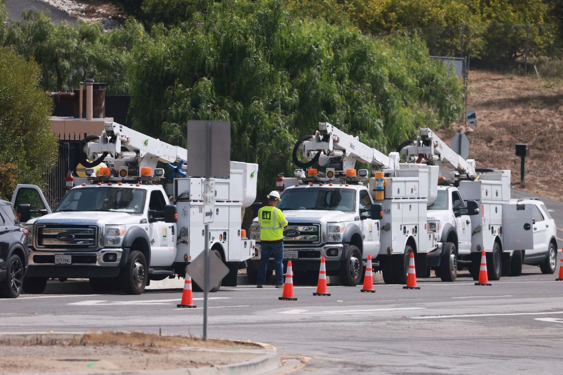 Utility vehicles are backed up in Rancho Palos Verdes, California, as earth movements in the area threaten power lines.