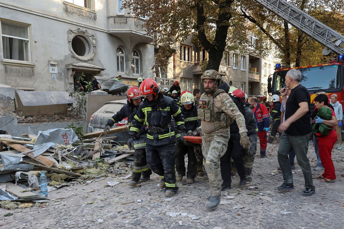 Emergency workers carry the body of a person killed during a Russian drone and missile strike in Lviv, Ukraine on September 4, 2024.