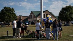 A man lays flowers at the site of a makeshift memorial at Apalachee High School the day after a fatal shooting left four dead in Winder, Georgia, U.S. September 5, 2024. REUTERS/Elijah Nouvelage