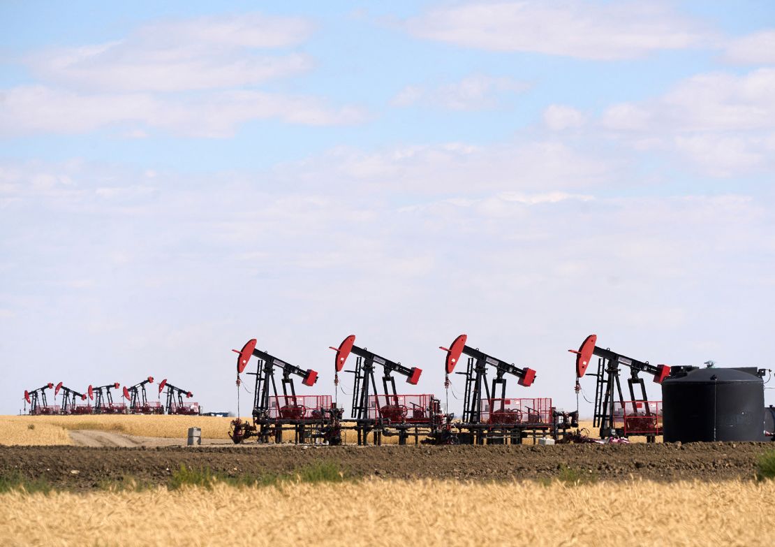 Oil pumpjacks and tanks are pictured in a farmer’s field near Kindersley, Saskatchewan, Canada September 5, 2024.