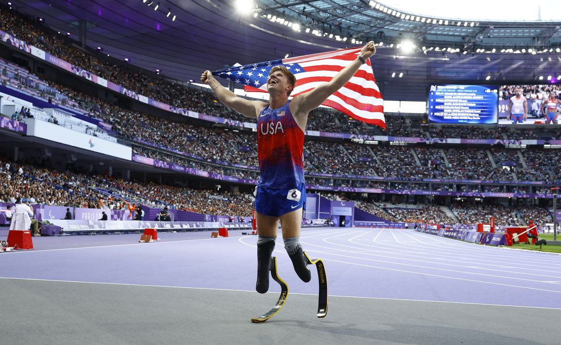 Team USA's Hunter Woodhall celebrates after winning gold at the Paris 2024 Paralympics.