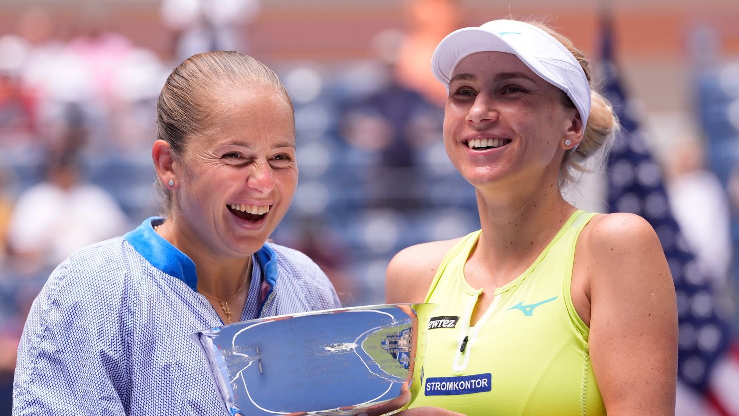 Lyudmyla Kichenok (right) and Jelena Ostapenko celebrate with the US Open trophy after winning the women's doubles final.