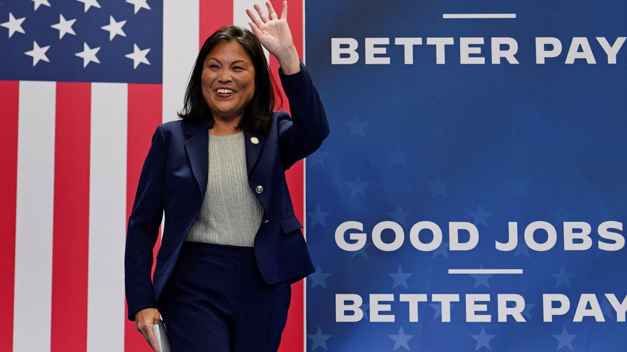 U.S. Acting Labor Secretary Julie Su waves onstage at the United Association Local 190 Training Center in Ann Arbor, Michigan, on September 6.