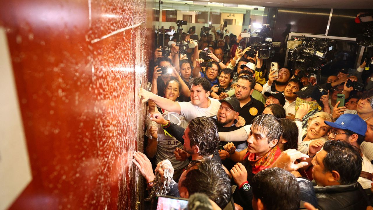 Demonstrators try to break down a door inside the Senate building as a highly contested judicial reform proposal is debated, following its approval by the Chamber of Deputies and backing by senators at the commission stage, in Mexico City, Mexico, September 10, 2024. REUTERS/Raquel Cunha