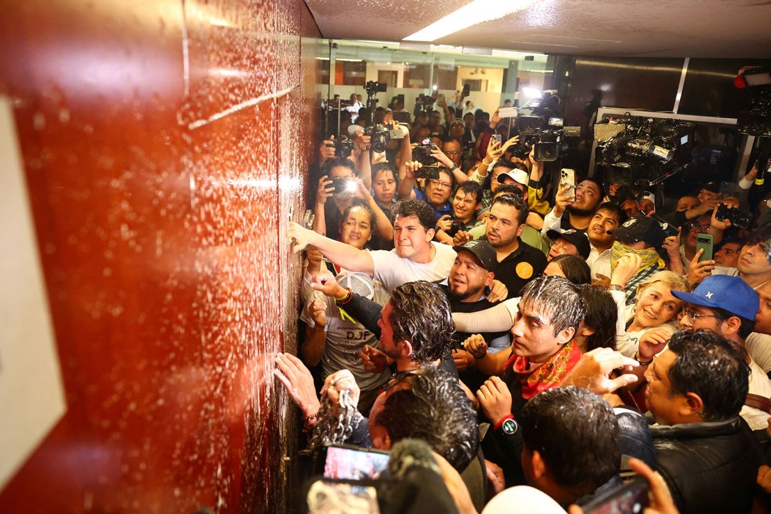 Demonstrators try to break down a door inside the Senate building as a highly contested judicial reform proposal is debated on September 10, 2024.