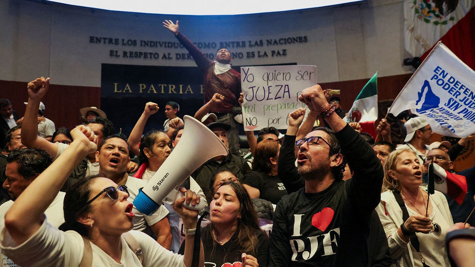 Demonstrators raise their fists after entering the Senate building on Tuesday, September 10.