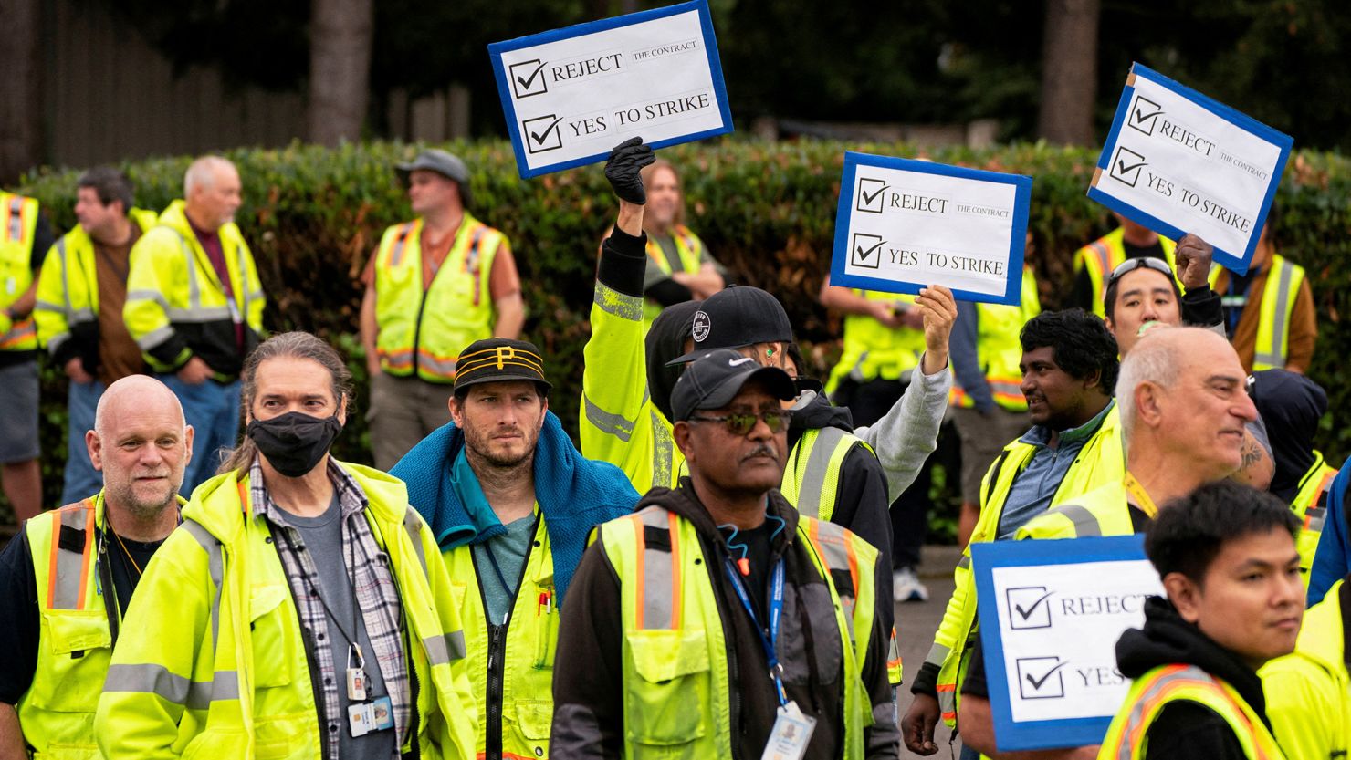 Boeing factory workers hold signs as they wait to vote on their first full contract in 16 years at an International Association of Machinists and Aerospace Workers District 751 union hall in Renton, Washington, on September 12.