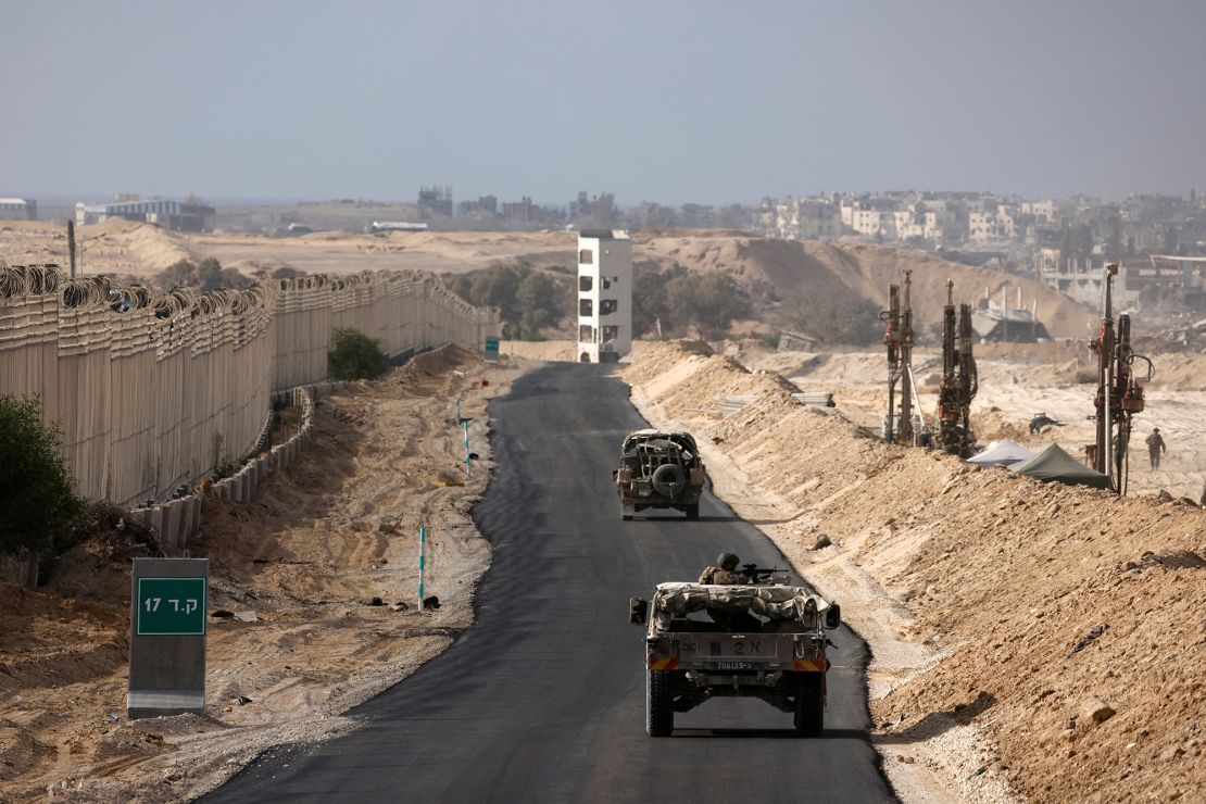 Israeli military vehicles drive through the Philadelphi Corridor area in southern Gaza, September 13, 2024.