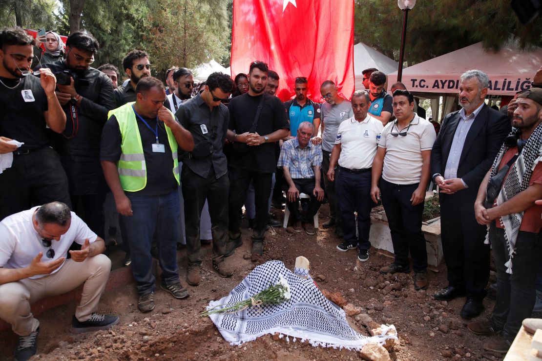 Mehmet Suat Eygi, father of Turkish-American activist Aysenur Ezgi Eygi killed in the Israeli-occupied West Bank, prays with relatives and friends next to her grave.