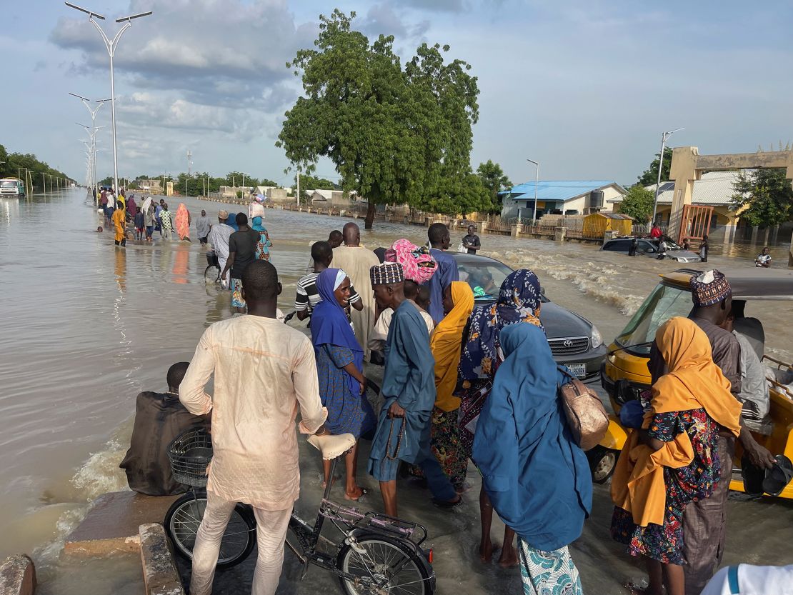 Residents leave the flooded areas with their belongings in Maiduguri, northern Borno state, Nigeria September 15, 2024. REUTERS/Ahmed Kingimi