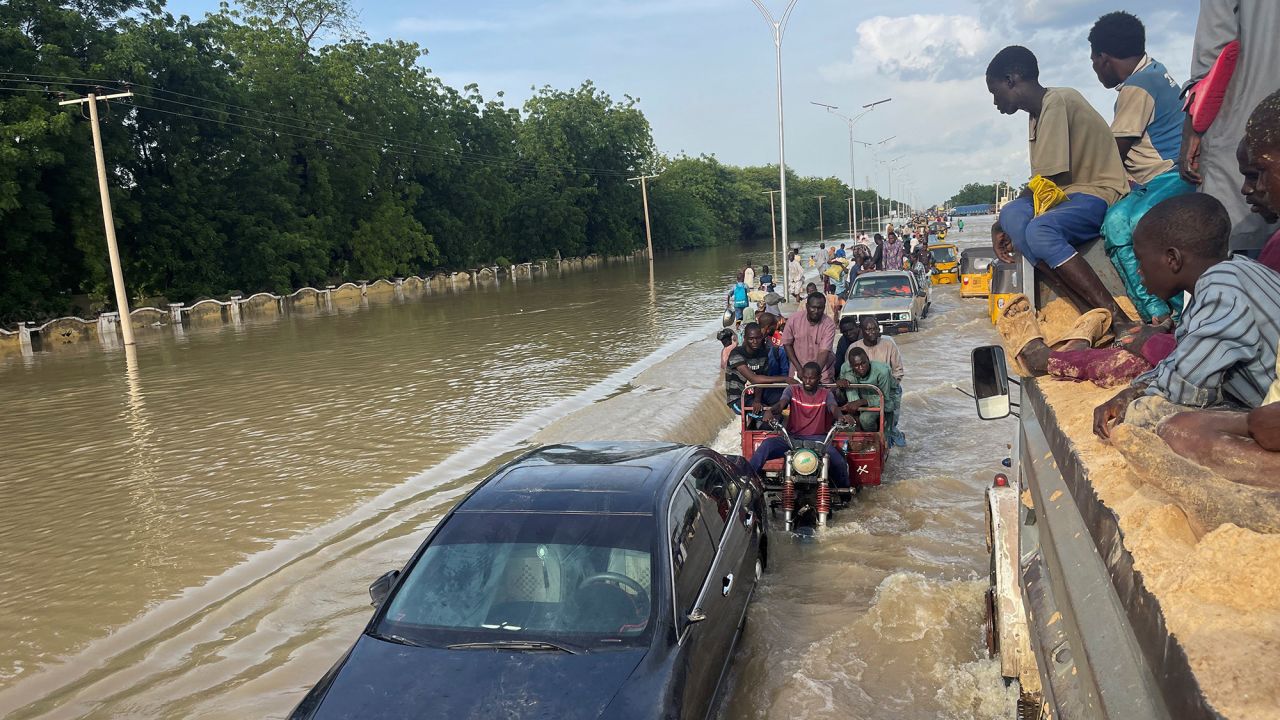 Residents leave the flooded areas with their belongings in Maiduguri, northern Borno state, Nigeria September 15, 2024. REUTERS/Ahmed Kingimi