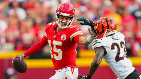 Sep 15, 2024; Kansas City, Missouri, USA; Kansas City Chiefs quarterback Patrick Mahomes (15) runs the ball against Cincinnati Bengals cornerback Dax Hill (23) during the first half at GEHA Field at Arrowhead Stadium. Mandatory Credit: Jay Biggerstaff-Imagn Images