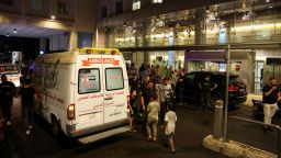 People walk near an ambulance outside American University of Beirut Medical Center (AUBMC) as people, including Hezbollah fighters and medics, were wounded and killed when the pagers they use to communicate exploded across Lebanon, according to a security source, in Beirut, Lebanon September 17, 2024. REUTERS/Mohamed Azakir 

 