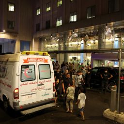 People walk near an ambulance outside American University of Beirut Medical Center (AUBMC) as people, including Hezbollah fighters and medics, were wounded and killed when the pagers they use to communicate exploded across Lebanon, according to a security source, in Beirut, Lebanon September 17, 2024. REUTERS/Mohamed Azakir 

 