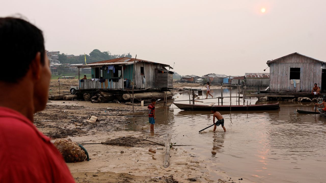 Children play next to floating houses on the dry banks of Lake Tefe during what the National Center for Monitoring and Early Warning of Natural Disasters (Cemaden) says is the most intense and widespread drought Brazil has experienced since records began in 1950, near Tefe, Amazonas state, Brazil September 17, 2024.
