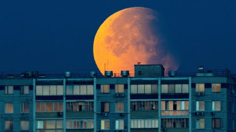 Partial lunar eclipse is seen over the residential building in Moscow, Russia, September 18, 2024. REUTERS/Maxim Shemetov     TPX IMAGES OF THE DAY     