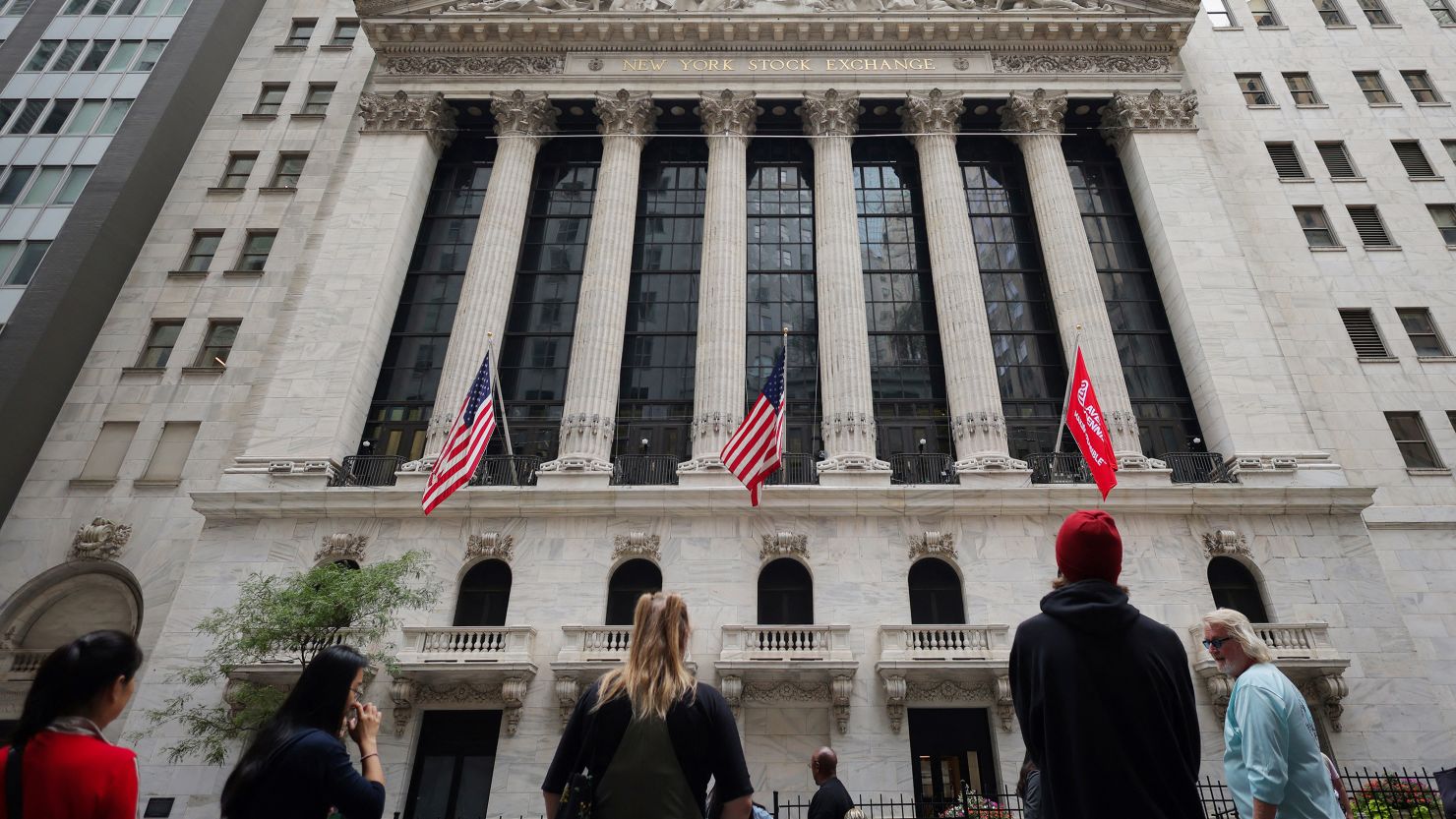 People look toward the New York Stock Exchange (NYSE) before the Federal Reserve announcement in New York City, September 18, 2024.