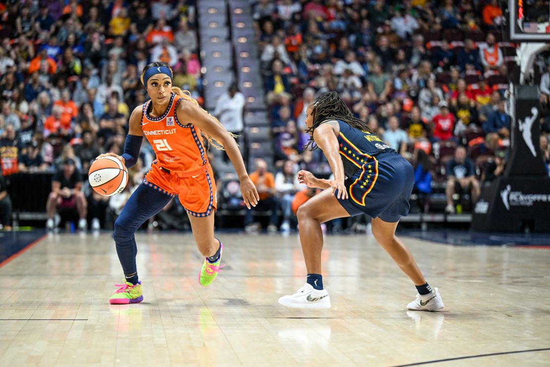 Connecticut Sun player DiJonai Carrington dribbles the ball against Indiana Fever.