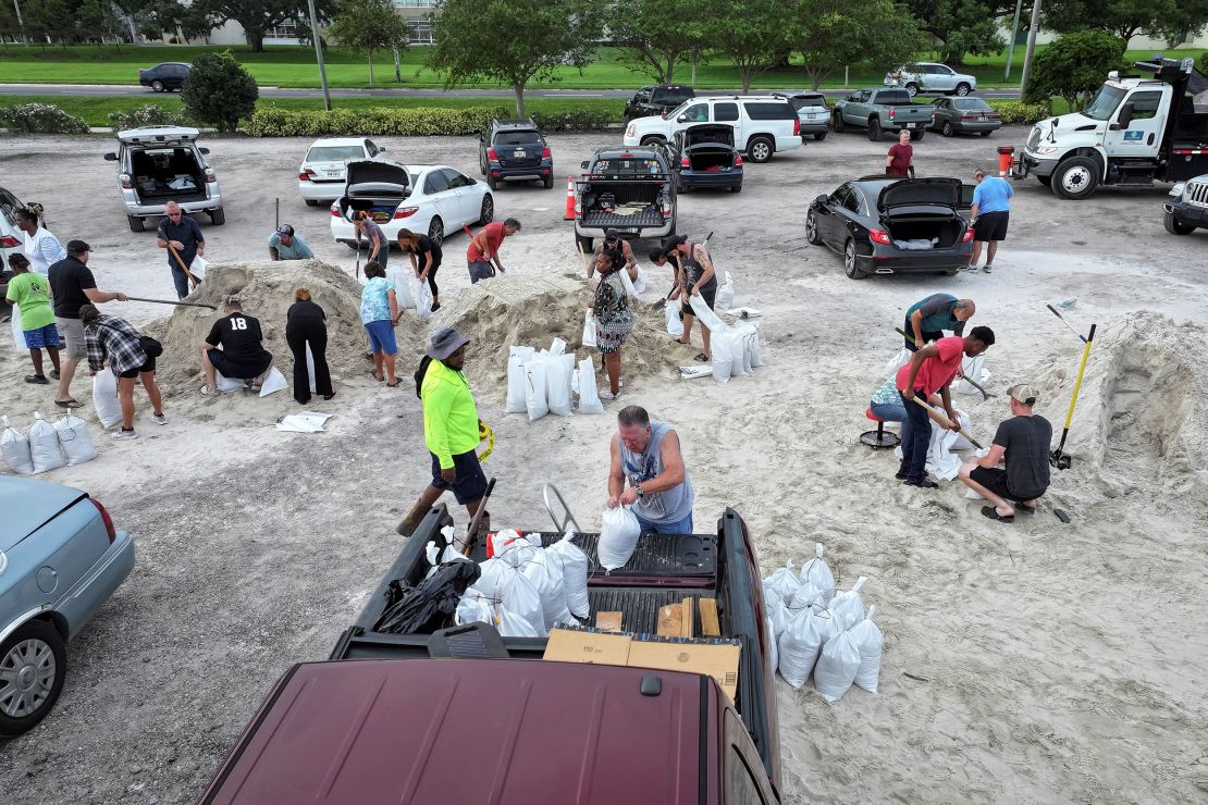 A drone view shows people filling up sandbags at Joe DiMaggio Sports Complex in Clearwater, Florida, ahead of Hurricane Helene on September 25, 2024.