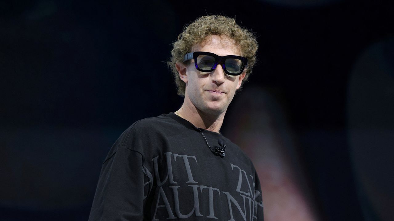 Meta CEO Mark Zuckerberg tries on the prototype of the Orion augmented reality glasses at the Meta Connect event in Menlo Park, California, on September 25, 2024.
