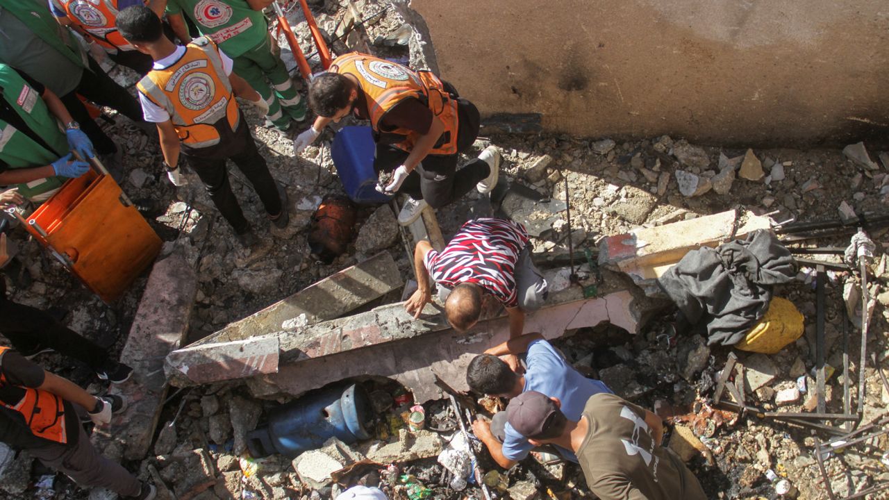 Palestinians inspect the site of an Israeli strike on a school sheltering displaced people in Jabalia, Gaza, on September 26.