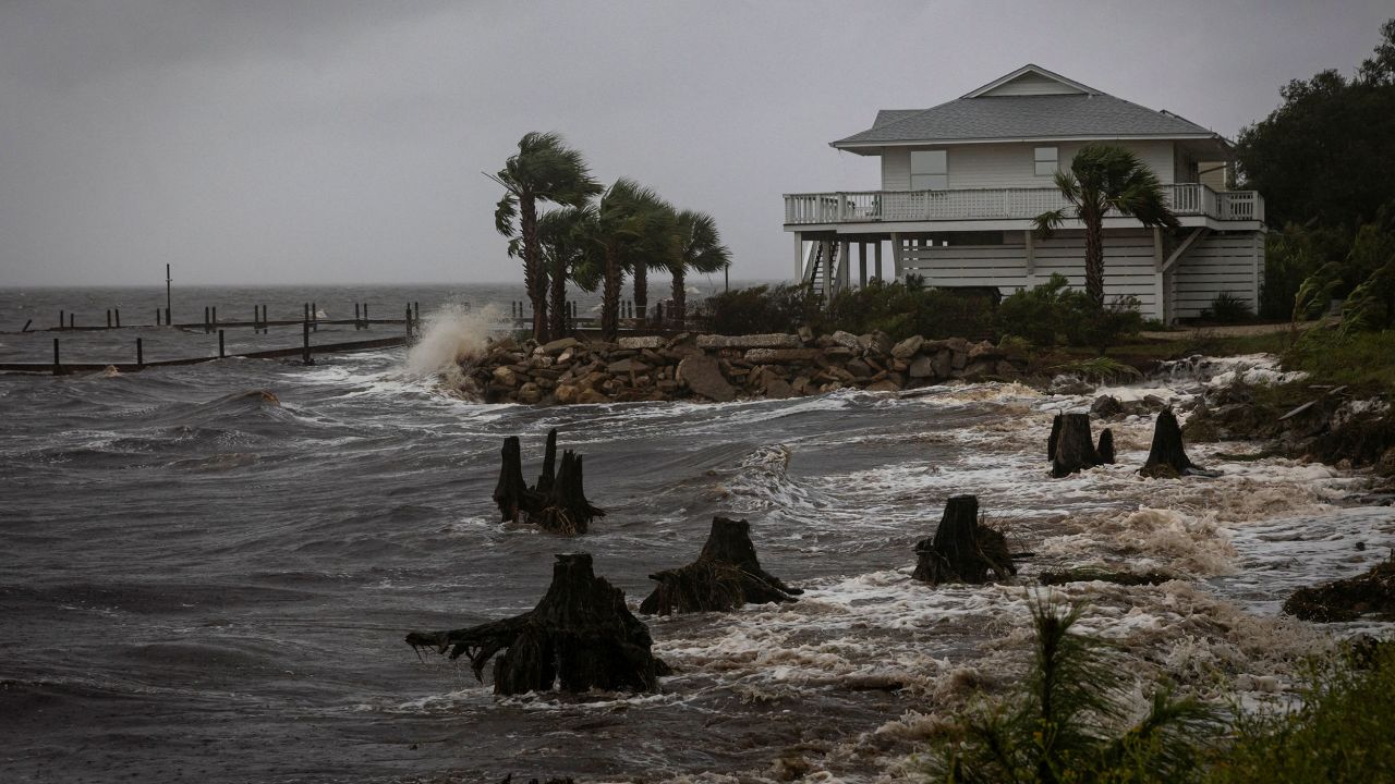 Waves impact a house seawall in Eastpoint, Florida, on Thursday.